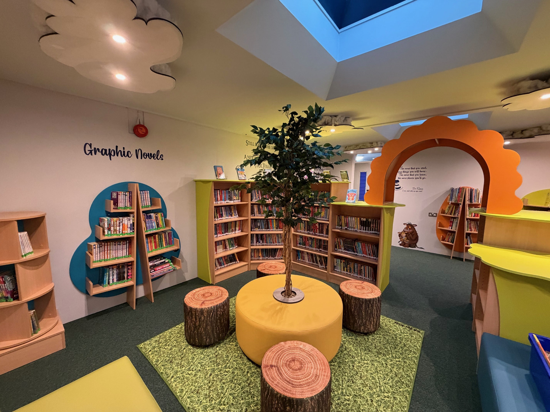 The newly opened Buckingham Primary School library with colourful shelving, tree seating and a Gruffalo mural